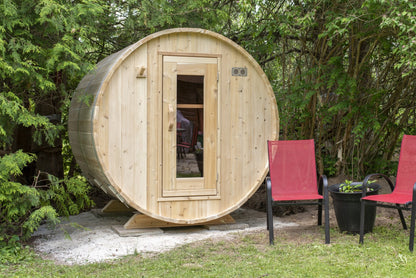 Barrel sauna front view in a garden setting