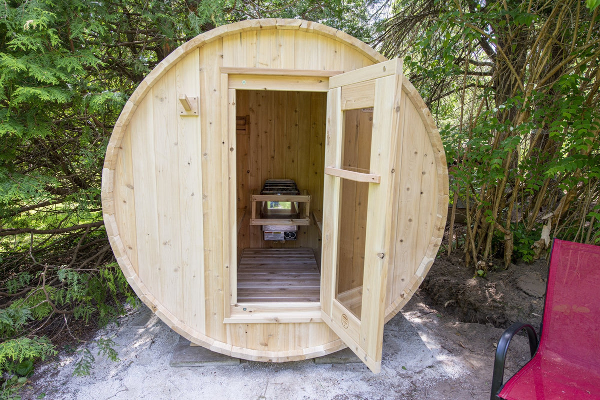 Barrel sauna with open door showing cedar benches