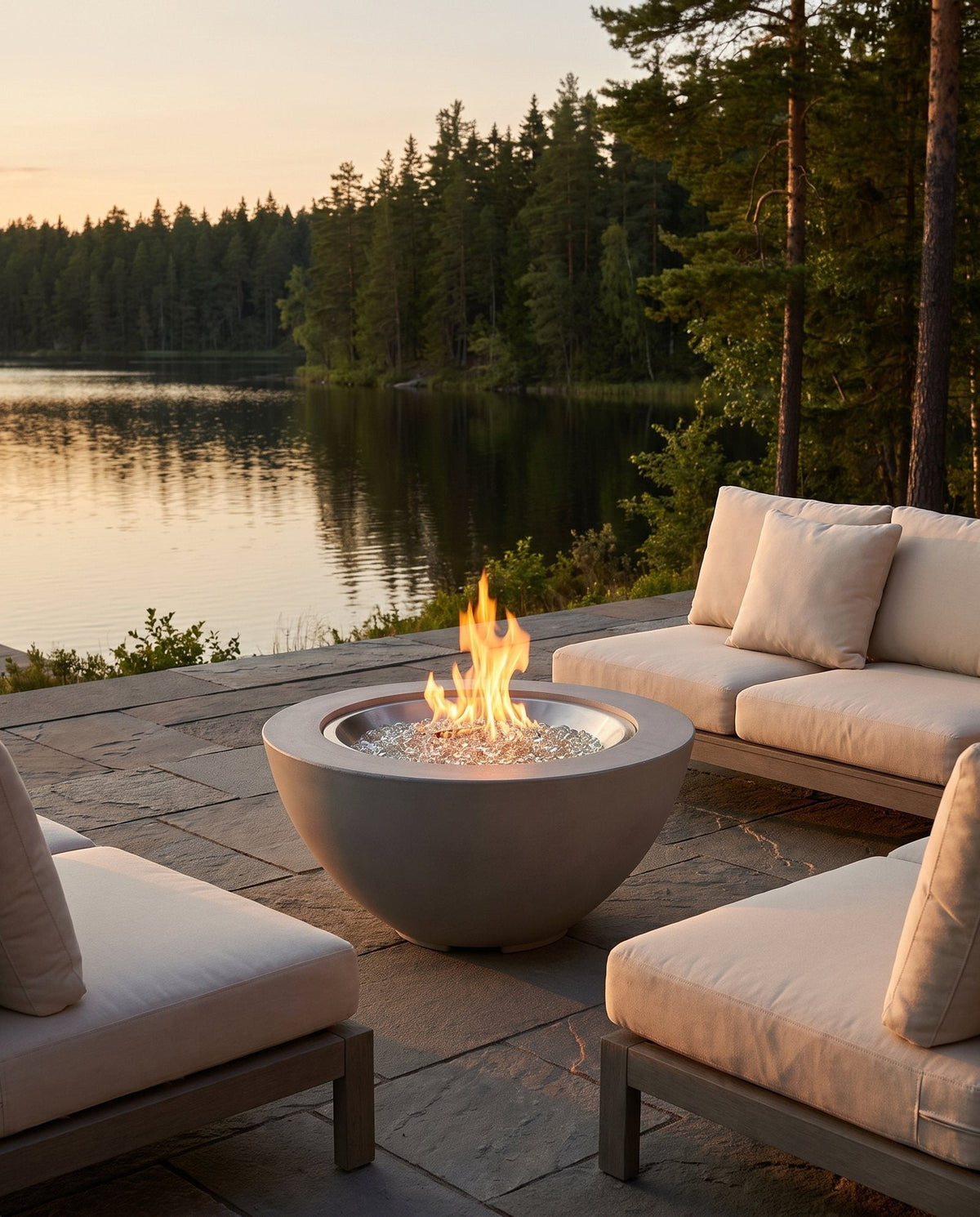Outdoor GreatRoom Cove round concrete gas fire bowl lit on an outdoor patio