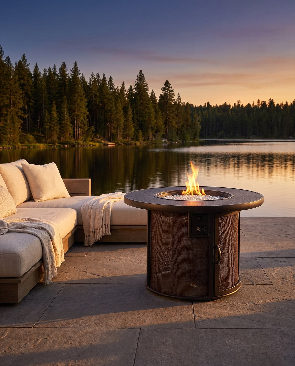 Outdoor GreatRoom Stonefire round gas fire pit table lit on an outdoor patio